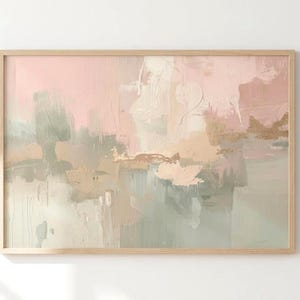 May include: Abstract art print in a light wooden frame. The artwork features a soft color palette of pink, green, beige, and gold. The painting has a textured, layered appearance, with visible brushstrokes and a modern aesthetic.