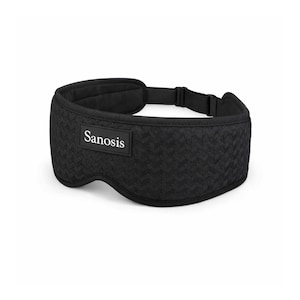 May include: A black sleep mask featuring a textured chevron pattern and a rectangular patch with the white text Sanosis centred on the front. The mask includes a smooth black adjustable strap with a plastic buckle for a secure fit around the head.