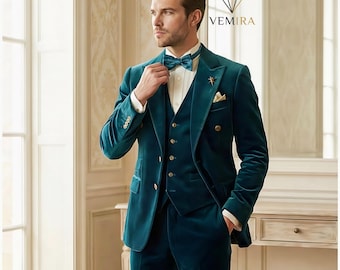 May include: Teal velvet three-piece suit with a double-breasted jacket, vest, and trousers. The suit features gold buttons and a matching bow tie. A white dress shirt and pocket square complete the formal ensemble. The VEMIRA logo is visible in the background.