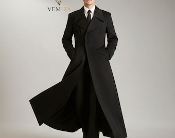 May include: A long, black overcoat with a double-breasted design. The coat features a notched collar, a slit in the back, and a tailored fit. The model is wearing a white shirt and black tie. The VEMIRA logo is visible in the upper left corner.