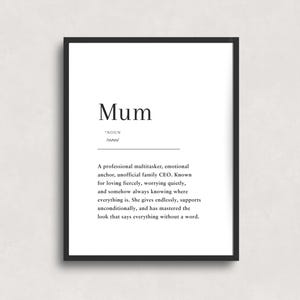 May include: A framed print with the word "Mum" in a minimalist design. The black frame surrounds white text that defines "Mum" as a noun, describing a loving, supportive, and endlessly giving person.