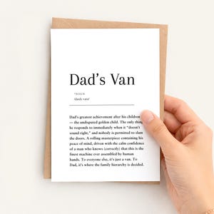 May include: A white greeting card with black text featuring a dictionary-style definition of Dad's Van. The text describes the van as a rolling masterpiece and the family hierarchy. The card is placed inside a brown kraft paper envelope.
