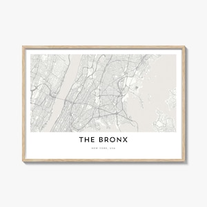 May include: A framed print of a map of The Bronx, New York, USA. The map is in grayscale, showing streets, waterways, and land features. The text "THE BRONX" and "NEW YORK, USA" are printed at the bottom of the print.