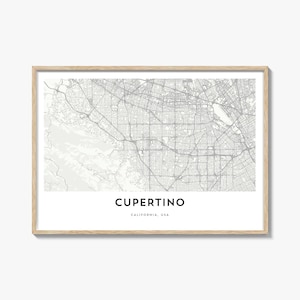 May include: A framed print featuring a detailed map of Cupertino, California, USA, in shades of gray. The city name is displayed in a bold, black font at the bottom, with the state and country below. The frame is a light wood color.