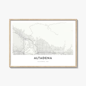 May include: A framed map print of Altadena, California, USA. The map is a detailed, minimalist design in shades of gray, showcasing streets and topography. The text "ALTADENA" is centered at the bottom, with "CALIFORNIA, USA" below it. The frame is a light wood color.