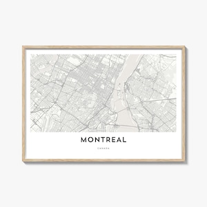 May include: A framed map print of Montreal, Canada, in grayscale. The city map is detailed, showing streets and waterways. The word "MONTREAL" is printed in a bold, black font, with "CANADA" below it. The frame is a light wood color.