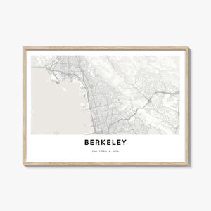 May include: A framed map print of Berkeley, California, USA. The map is in grayscale, showing streets, waterways, and geographical features. The city name is printed in a bold, sans-serif font below the map.
