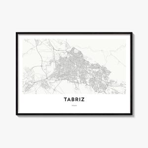 May include: A framed wall art print featuring a detailed grey and white street map of Tabriz, Iran. The map displays intricate road networks against a light background, with the text TABRIZ and IRAN printed in bold black capital letters below.