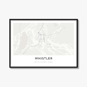 May include: A framed map print of Whistler, British Columbia, Canada. The map features a light beige background with grey lines representing roads and geographical features. The text WHISTLER and BRITISH COLUMBIA, CANADA is printed below.
