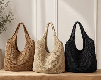 May include: Three hobo-style shoulder bags made of woven material, arranged in a row. The bag on the left is dark tan, the center bag is light beige, and the bag on the right is black. Each bag features a single integrated handle and a textured surface.