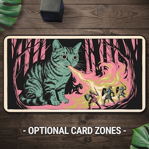 May include: A rectangular playmat featuring a large, teal-striped cat breathing a stream of yellow and pink fire towards three small armoured knights with shields and swords, set against a dark forest background with pink accents and text.