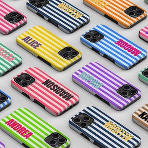 Puede incluir: Una colección de fundas rectangulares para smartphone con rayas verticales en varios colores, incluyendo rosa, azul, amarillo, verde, morado, naranja y marrón. Cada funda muestra un nombre personalizado en una fuente negrita.