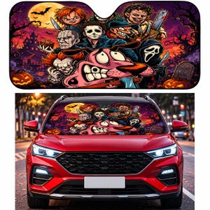 May include: A rectangular car windshield sunshade featuring a colorful graphic print of various horror movie characters and a pink cartoon dog. The scene includes a full moon, a haunted house, pumpkins, and a tombstone with the text CREEP IS REAL.
