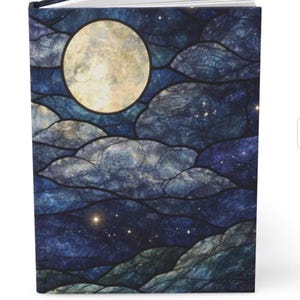 May include: A hardback journal with a celestial design. The cover features a full moon in a yellow hue, set against a dark blue night sky with cloud-like shapes and scattered stars. The journal's design evokes a sense of wonder.