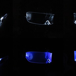 May include: Two pairs of LED light-up glasses, one pair is white and the other pair is blue. The glasses are clear and have a futuristic design.