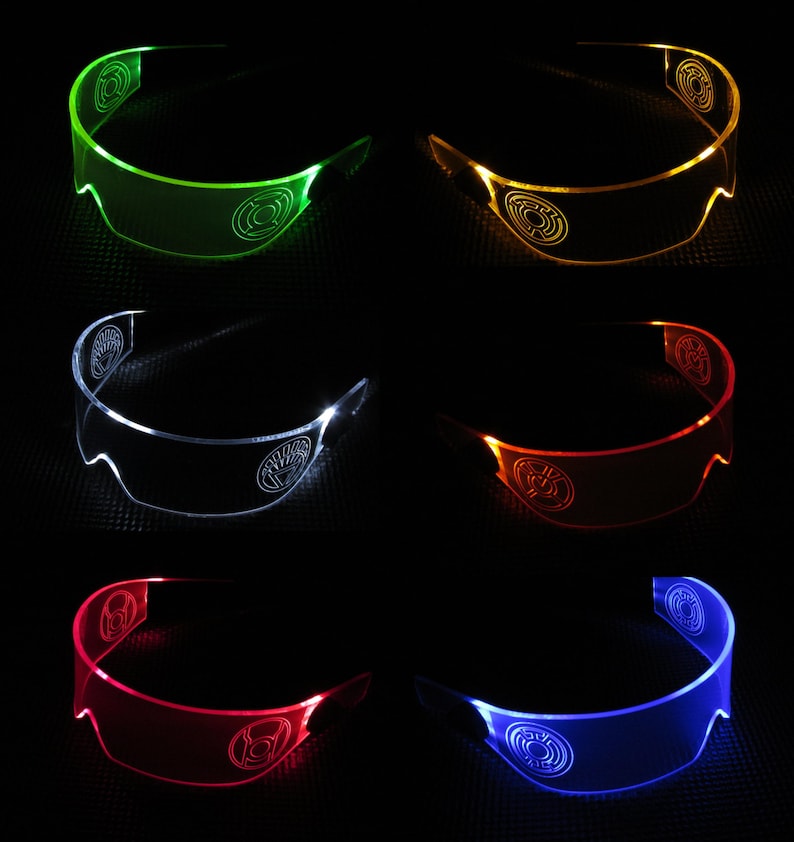 May include: Set of six LED light-up glasses in various colors, including green, yellow, white, orange, red, and blue. Each pair of glasses has a unique design with a symbol in the center.