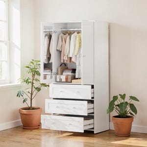 May include: A white wardrobe with three drawers and a hanging rod for clothes. The wardrobe doors are open, revealing hanging garments. Two potted plants flank the wardrobe, one on each side. The room has a light, airy feel.