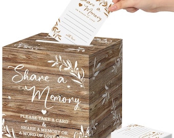 Puede incluir: Una caja cuadrada de madera con un patrón de grano de madera marrón rústico, con texto blanco que dice Share a Memory y Please take a card & share a memory or a word of love here, decorada con ilustraciones de hojas blancas y una ranura.