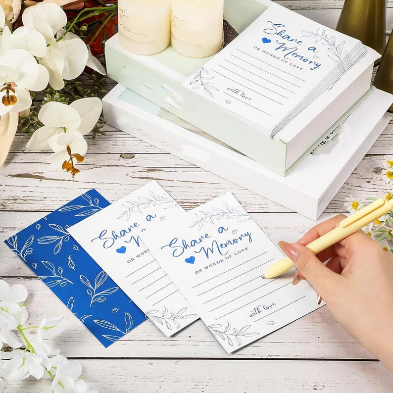Share a Memory card set with 50 premium double sided guest message cards and foldable keepsake box featuring greenery botanical design and transparent display windows on all four sides. Thick cardstock memory cards with wide collection slot for weddings, graduations, birthdays, anniversaries, retirement parties, bridal showers, family gatherings, and elegant guest book alternative displays.
