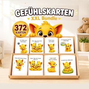 Könnte beinhalten: Ein Set von Gefühlskarten, das "XXL Bundle", mit 372 Karten. Die Karten zeigen Cartoon-Bilder eines gelben Löwenjungen, der verschiedene Emotionen ausdrückt. Die Karten werden in einer Holzkiste mit deutschem Text präsentiert.