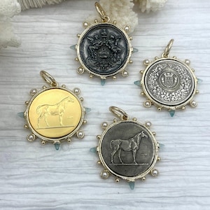 May include: Four round pendants with gold-colored bails. Two pendants feature a horse design, one in gold and the other in silver. The other two pendants have detailed relief designs, one with figures and the other with floral elements. Each pendant is accented with pearls and blue-green stones.