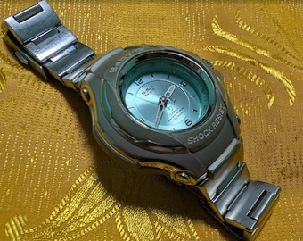 Reloj Casio G-ms STG-100 Premium Baby-G Shock Resist vintage de 42 mm, color plata y azul, funcionando (año 2000).
