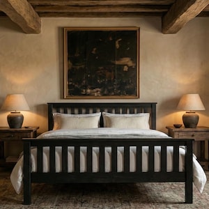 May include: A bedroom with a black wooden bed frame and slatted headboard and footboard. Two bedside tables with lamps are either side of the bed. An abstract painting hangs above the bed, and the room has a neutral colour scheme.