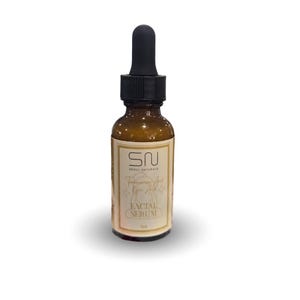 May include: A brown glass bottle of facial serum with a black dropper. The label reads "SN SEOUL NATURALS" and "Tranexamic Acid Kojic Acid" with "FACIAL SERUM" below. The bottle contains 1 oz of product.