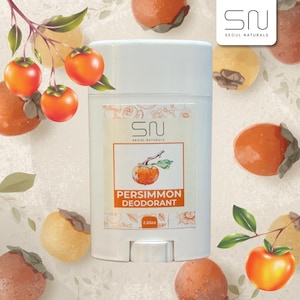May include: White deodorant stick with the text "Persimmon Deodorant" and a persimmon fruit illustration. The product is labeled "2.65oz" and is surrounded by persimmon fruit and leaves.