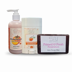 May include: A collection of Seoul Naturals persimmon-scented body care products. Includes a body wash, deodorant, and a 6 oz soap bar. The body wash is in a pink bottle with a pump, the deodorant is white, and the soap is brown.