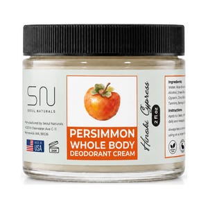 May include: A clear glass jar with a black lid containing Seoul Naturals Persimmon Whole Body Deodorant Cream. The label features a watercolor persimmon illustration, the text Hinoki Cypress, and a volume of 2 fl oz, with ingredient and instruction lists.