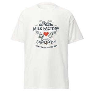 May include: White t-shirt with a graphic design featuring the text "MILK FACTORY" above a heart, coffee cup, and baby bottle. The phrase "Powered by Coffee & Love" and "NIGHT SHIFT SUPERVISOR" are also printed on the shirt.