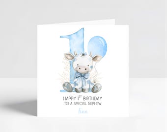 May include: A square greeting card with a watercolor illustration of a white and blue cow with a blue bow, sitting in front of a blue number 1 and a balloon. The text reads "Happy 1st Birthday to a special nephew" and the name "Finn".
