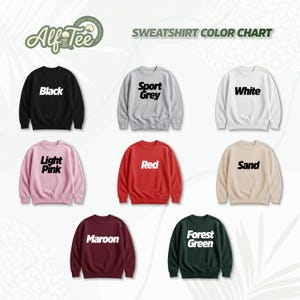 Pode incluir: Um gr&aacute;fico de cores de camisolas de gola redonda em v&aacute;rias cores, incluindo preto, cinza desportivo, branco, rosa claro, vermelho, areia, bord&ocirc; e verde floresta. Cada camisola tem o nome da cor impresso em letras brancas.