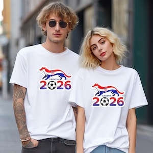 May include: White t-shirts with a Croatia-themed graphic. The design features a stylized animal in the colors of the Croatian flag, the word "Croatia", the number "2026", and a soccer ball.