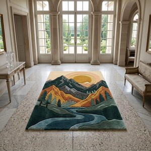 May include: A rectangular area rug featuring a mountain landscape design. The rug depicts a river, mountains, and a setting sun in shades of blue, green, orange, and yellow. The rug is placed on a marble floor in a large room.