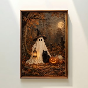 May include: A framed wall art print depicting a ghost wearing a black witch hat and holding a lit lantern. A black cat sits beside the ghost in a forest filled with orange autumn leaves, a glowing jack-o'-lantern, and a full moon in the sky.