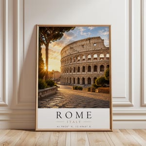 May include: A framed vertical wall art print featuring a photograph of the Colosseum in Rome, Italy, at sunset. The image shows the stone amphitheatre, a tall pine tree, and a cobblestone path. Below the photo, the text reads ROME ITALY 41.9028 N, 12.4964 E.