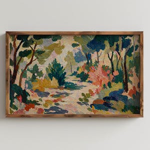 May include: A framed landscape painting with a path winding through a forest. The artwork features a palette of greens, blues, yellows, and pinks, with visible brushstrokes. The wooden frame adds a rustic touch to the artwork.