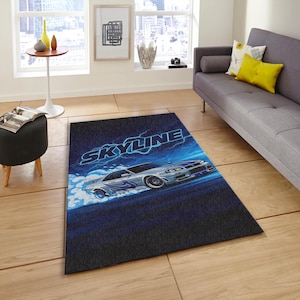 May include: Rectangular area rug featuring a silver sports car design with the word "SKYLINE" in blue and white. The rug has a dark blue background with a light blue and white design of the car in motion.