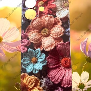 May include: A rectangular smartphone case featuring a printed pattern of various crocheted flowers in shades of peach, light blue, dark pink, and yellow. The design includes circular cutouts at the top for a camera lens and flash, with a smooth finish.