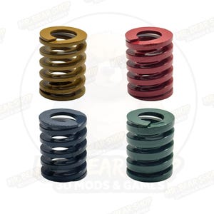 May include: Four coil springs in gold, red, navy blue, and green. Each spring is cylindrical with a flat top and bottom, and the coils are evenly spaced. The springs are likely for mechanical or industrial use.