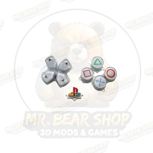 May include: A set of replacement gaming controller buttons including a translucent white directional pad with black arrows, four action buttons with colored geometric symbols, and a small PlayStation logo button with red, blue, and green accents.