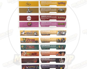 May include: A sheet of Game Boy Advance labels featuring various game titles and characters. The labels are rectangular with colorful backgrounds and include text such as "Pokemon", "Zelda", and "Dragon Ball Z".