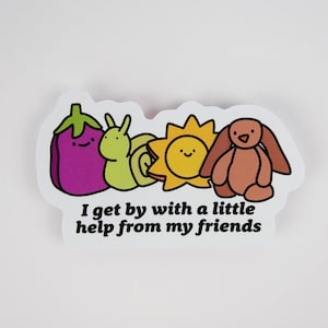 May include: A sticker featuring a purple eggplant, a green snail, a yellow sun, and a brown bunny. The text "I get by with a little help from my friends" is below the illustrations. The sticker has a white border.