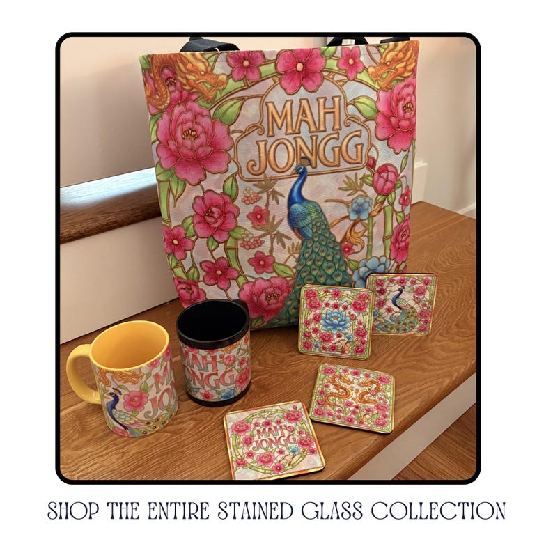 A collection of coordinating Mah Jongg-themed items, including a tote bag, mug, coasters, and a tumbler. The tote bag features a peacock and floral design with the words "Mah Jongg". The mug and coasters also have peacock and floral designs.