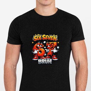 May include: Black t-shirt featuring a cartoon graphic of the numbers six and seven with faces, arms, and legs. The numbers are orange with white accents and the text "SIX SEVEN" and "BRUH" are above and below the numbers.