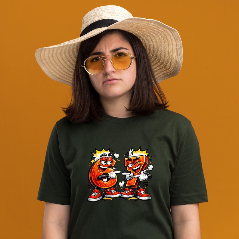 May include: Dark green t-shirt featuring a cartoon graphic of the numbers six and seven, each with a face, arms, legs, and red sneakers. The numbers are pointing at each other. The person in the image is wearing a straw hat and sunglasses.
