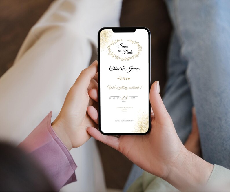 May include: A smartphone screen showing a digital wedding invitation. The invitation has gold text and floral details on a white background. The text says "Save the Date," "Chloe & James," and "We're getting married!" The date is May 23, 2024.