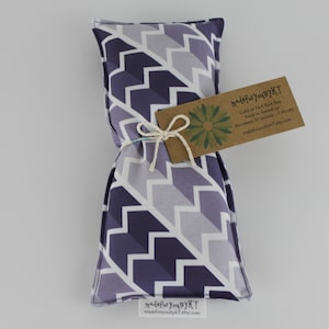 May include: A purple and white chevron patterned rice bag with a brown tag that reads "MadeforYouByKT Cold or Hot Rice Bag Keep in freezer or microwave for 30 seconds - 1 minute madeforyoubykt.etsy.com"